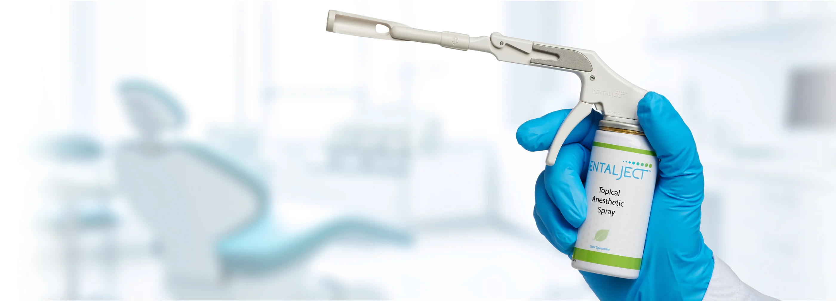 A gloved clinician holding the DentalJect applicator and canister in an operatory