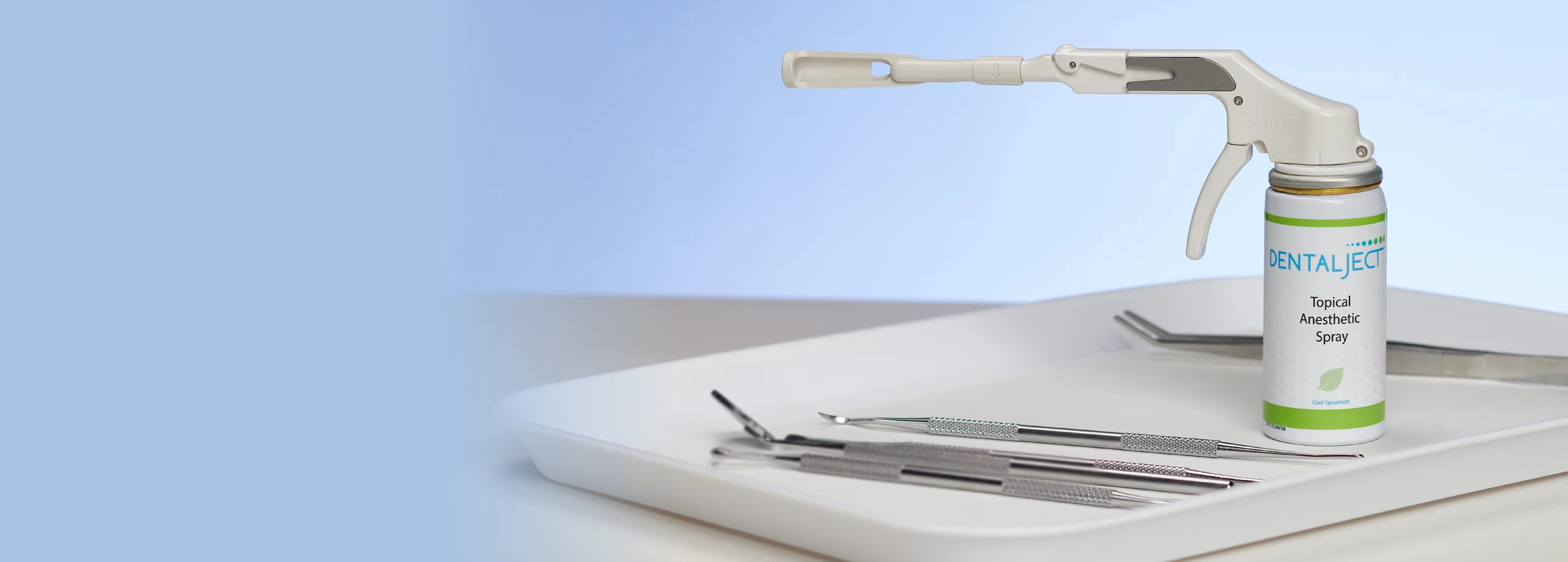 The DentalJect applicator and canister resting on a dental instrument tray