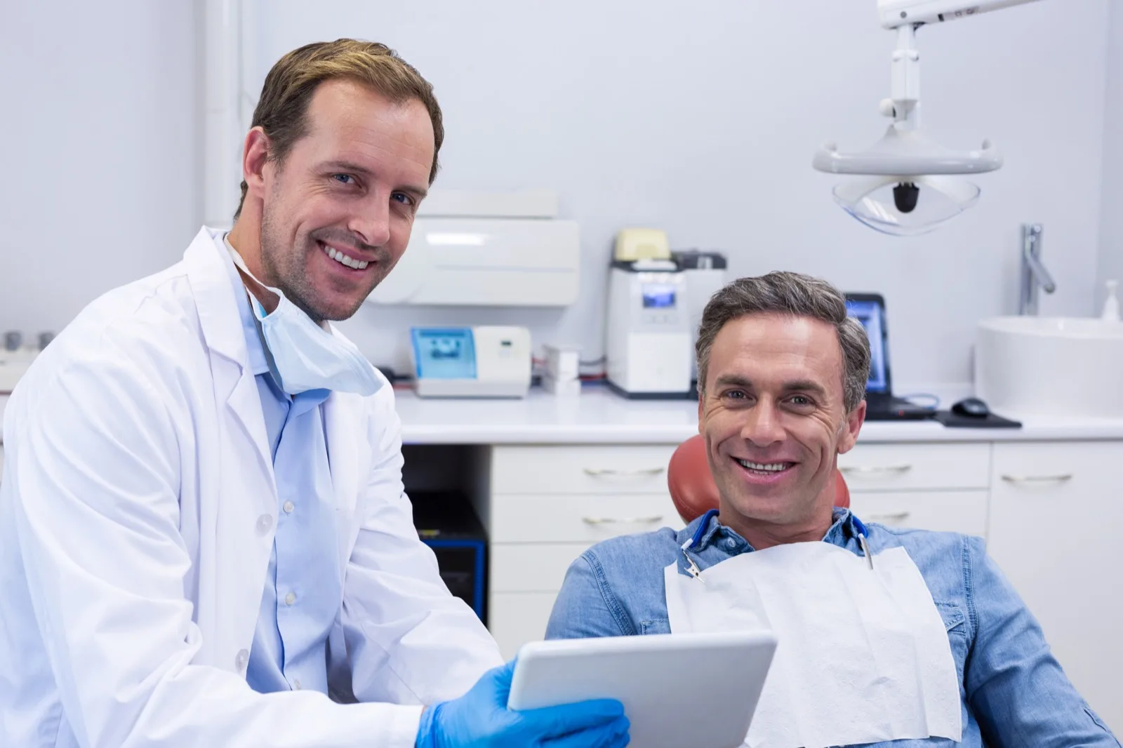 A dentist and patient reviewing treatment together in the operatory